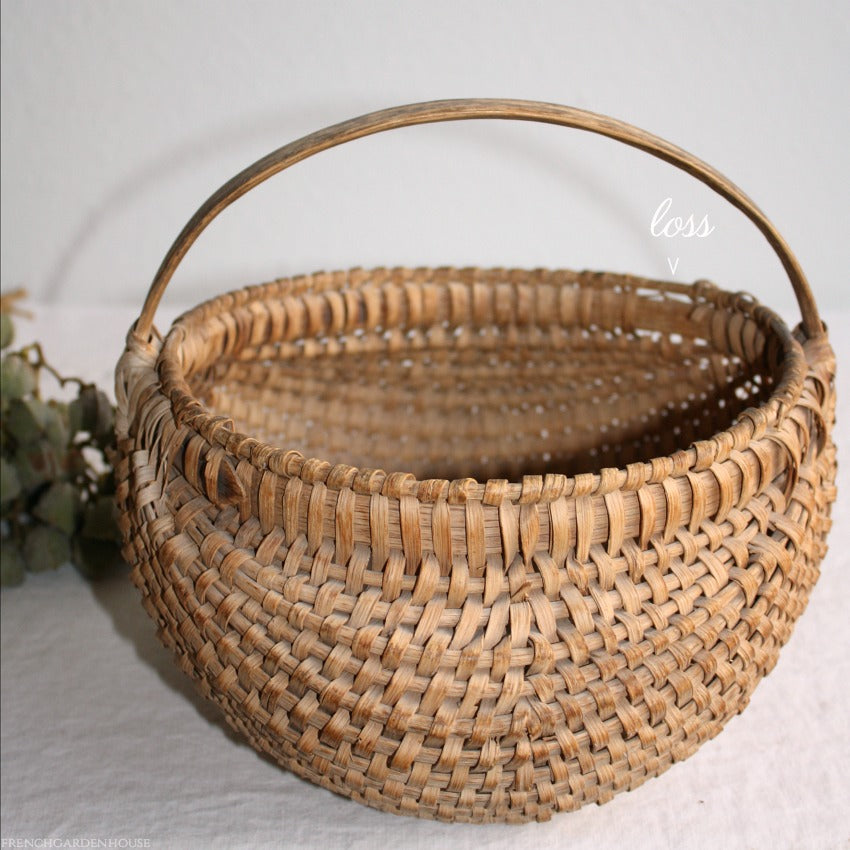 Close-up of hand-woven splint detail on antique French country basket