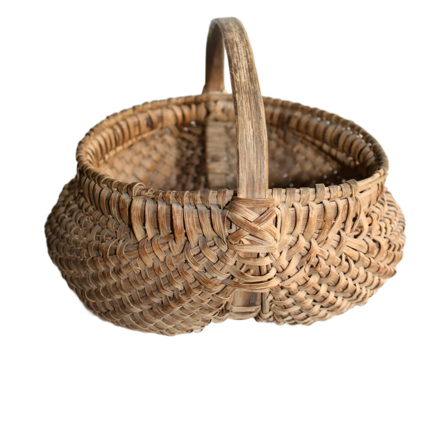 Side view of 19th Century French Panier à Fesses showing arched handle and double-wrapped rim
