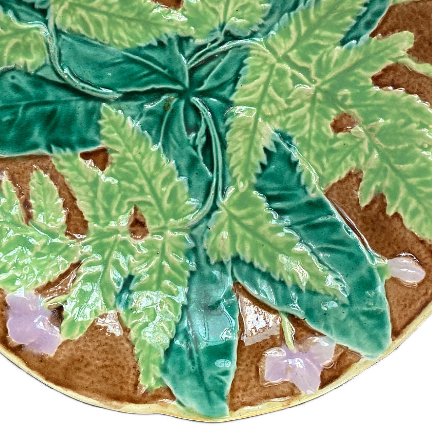 19th-century French Majolica plate with raised ferns and lavender flowers, lush glazes in green and brown, likely Sarreguemines or Orchies.