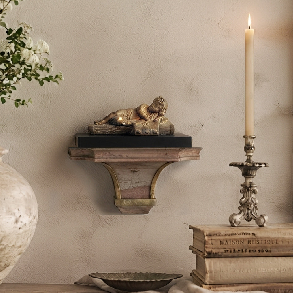 Antique Beaux Arts gilt bronze cherub sculpture styled with French books, white flowers, and candlelight