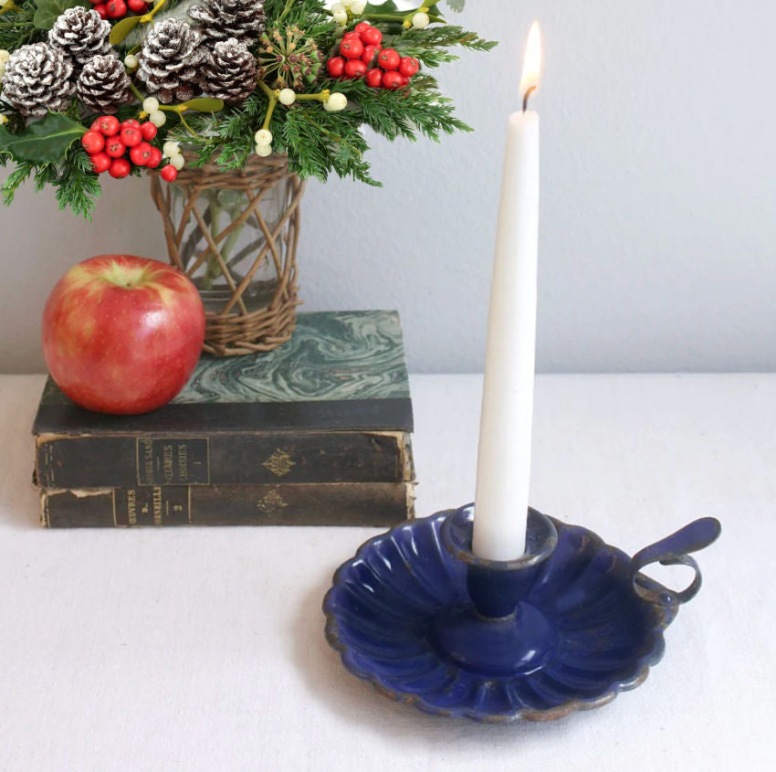 Charming Antique French Blue Enameled Candle Holder, a quintessential piece of 19th-century French country style. Crafted in tin with a beautifully worn classic French blue enamel finish, this piece exudes authentic rustic charm. The handle and raised rim showcase simple yet elegant craftsmanship, while the enamel has aged gracefully with time, revealing the character and patina only decades of use can bring.
Perfect for adding a touch of old-world ambiance to your décor, this candle holder brings warmth to