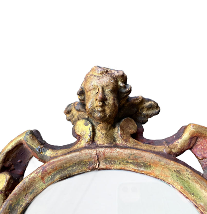 Antique decorative standing mirror with aged gold leaf and sculptural cherub design