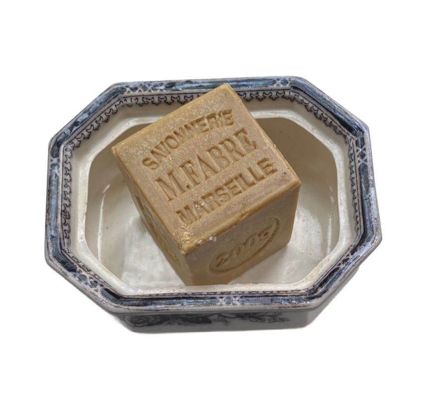 Bar of soap with 'Marseille' text in a decorative container on a white background