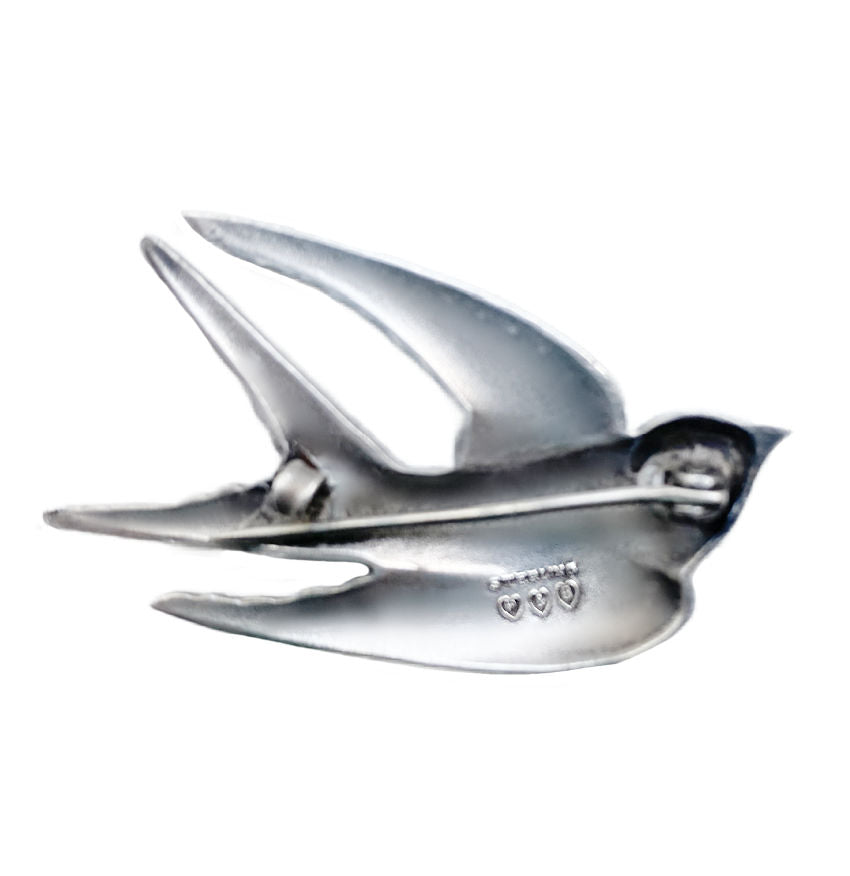 Rare Paye & Baker sterling silver swallow brooch with guilloché enamel and paste stones, c.1901–1910, a prized early Art Deco jewel.