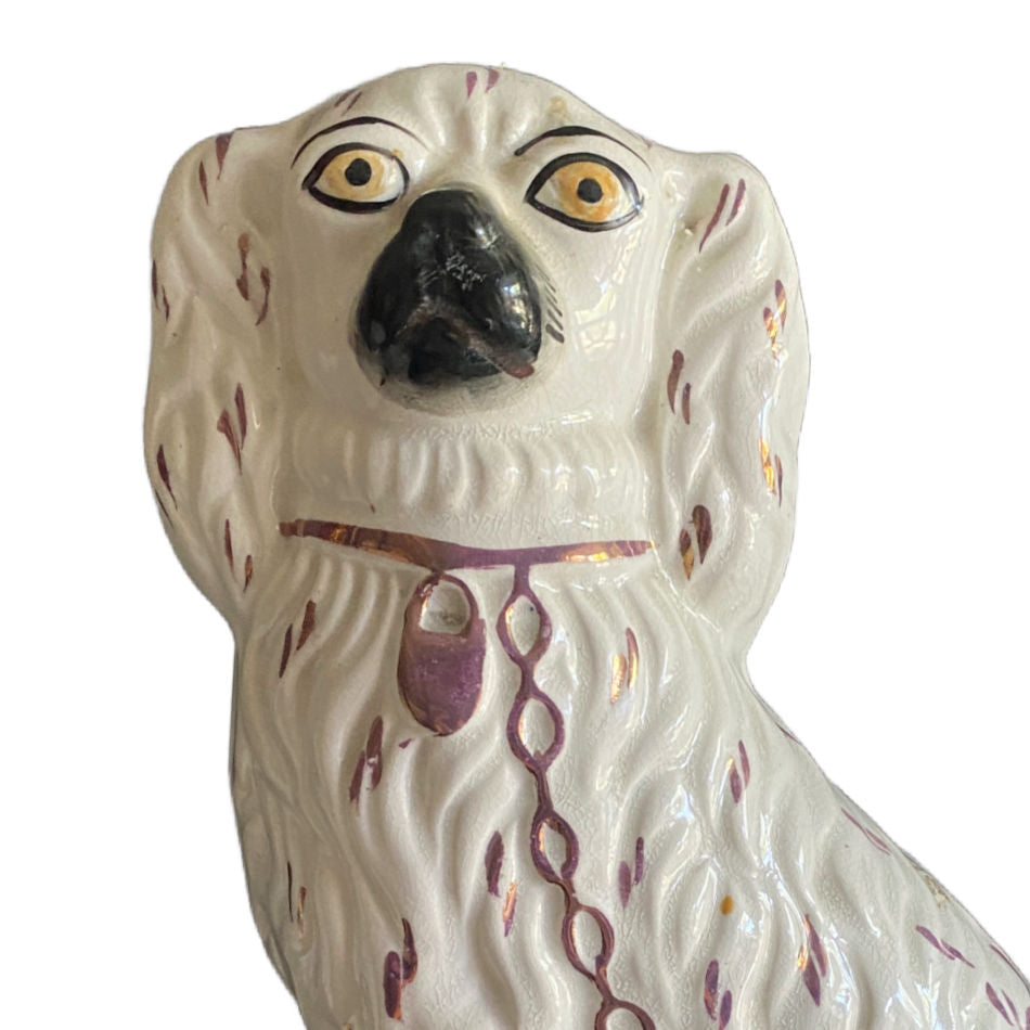 Antique Staffordshire dog figurine with hand-painted decorative accents facial view