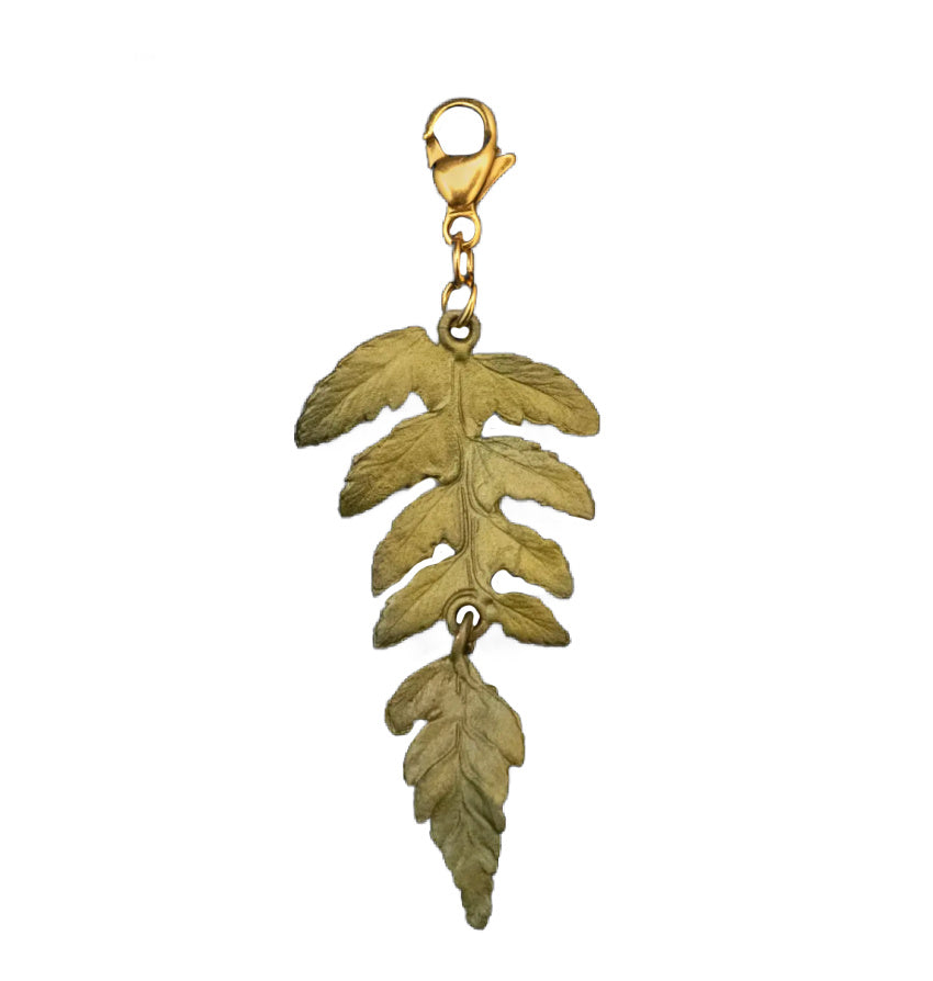 Cast Bronze Fern Charm with patinated finish, intricate fronds, artisan botanical jewelry, collectible nature-inspired design