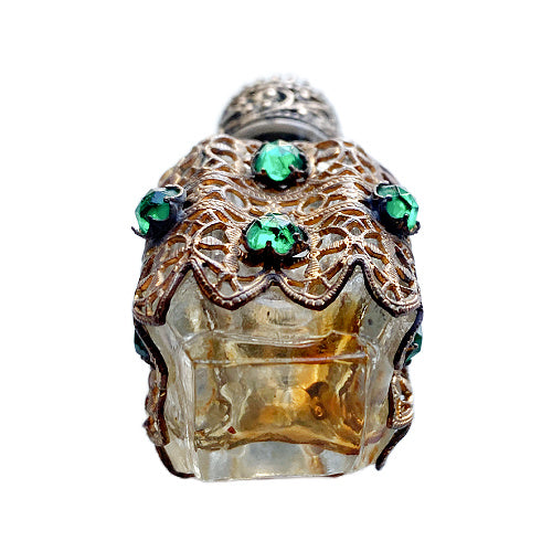 Exquisite Art Deco miniature perfume bottle adorned with emerald glass jewels and intricate gilt filigree. A romantic collector’s treasure of timeless elegance.