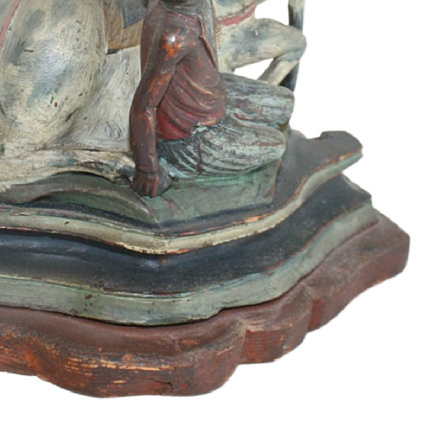 Base of antique hand carved wood horse and rider sculpture showing original stepped base and aged painted finish