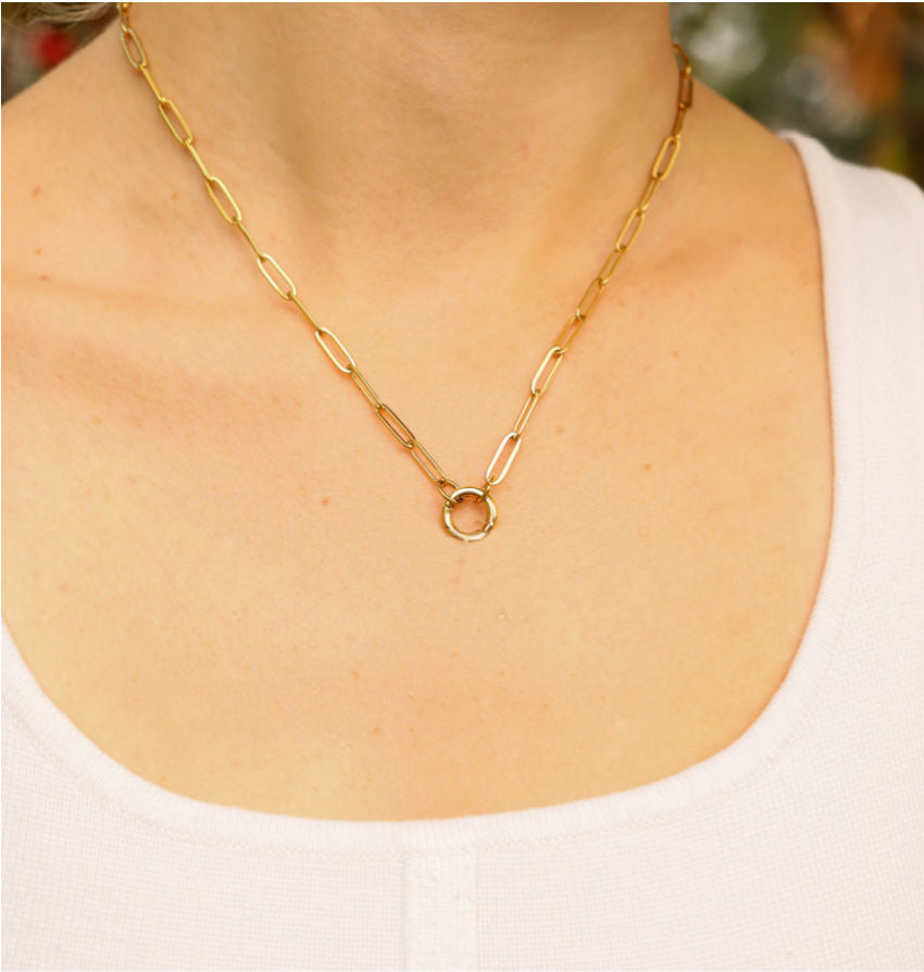 Heirloom charm keeper necklace in gold on model with white shirt