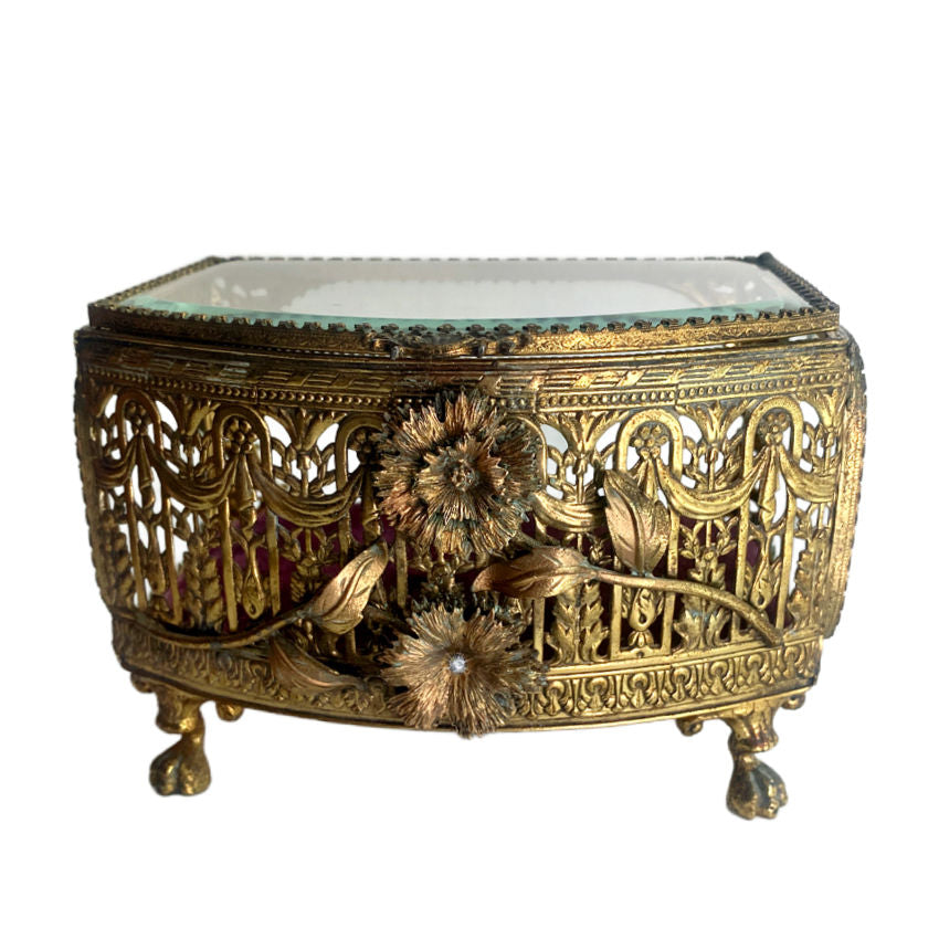 Ornate gilt filigree jewelry casket with beveled glass lid and deep pink silk velvet lining. A romantic statement piece for dressing table display.