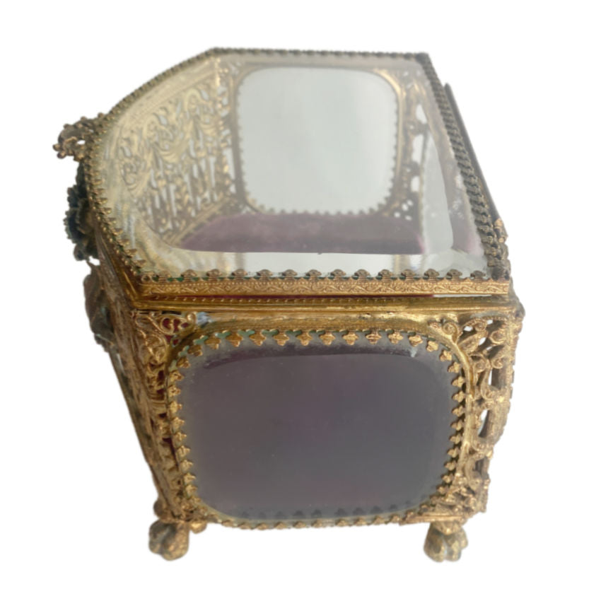 antique Gilt ormolu jewelry casket with beveled glass, filigree and a rhinestone accent, side view.