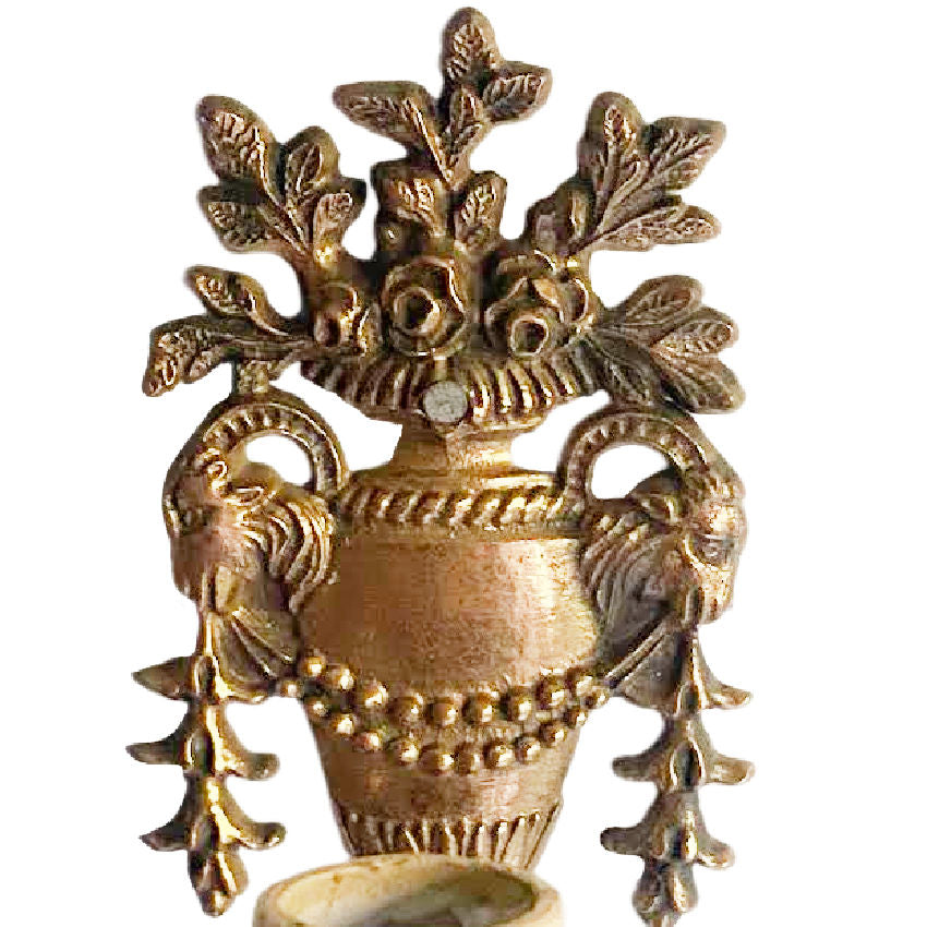 Ornate rose and rams heas garland detail on antique bronze wall sconces