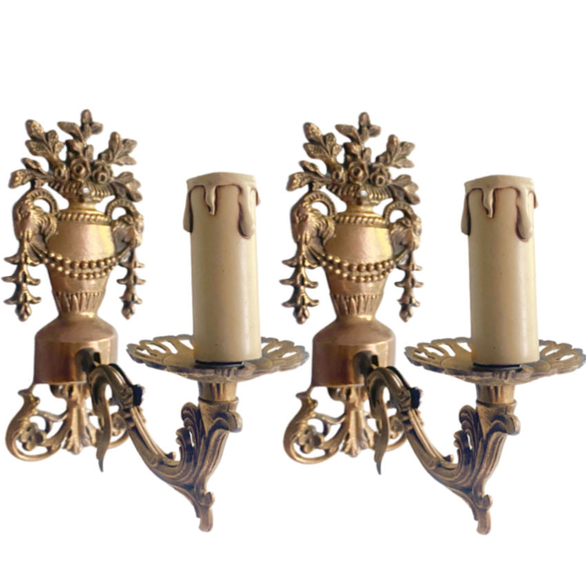 A pair of antique French bronze floral urn single light wall sconces with classical styling, featuring tall urns topped with roses, ram heads, and swagging garlands