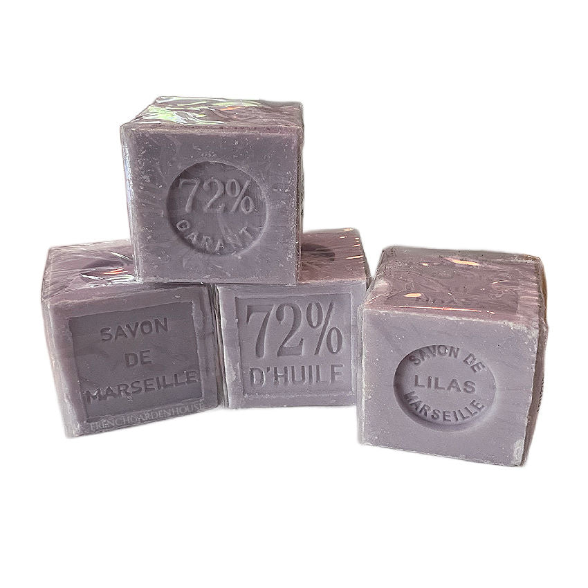 Four cubes of Petite Marseille soap with lilac scent, each stamped with '72% Paris', stacked two by two.
