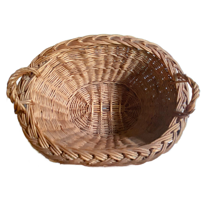 Handwoven vintage Dutch wicker basket close-up showing inside and tactile weave texture