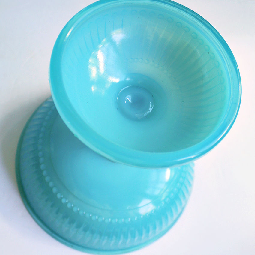 Antique French opaline glass bowl reflecting light with soft pastel blue tone bottom view
