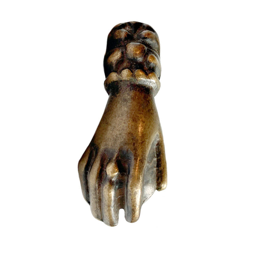 19th Century Bronzed Heurtoir Door Knocker in the shape of a lady's hand with an ornate cuff, against a white background.