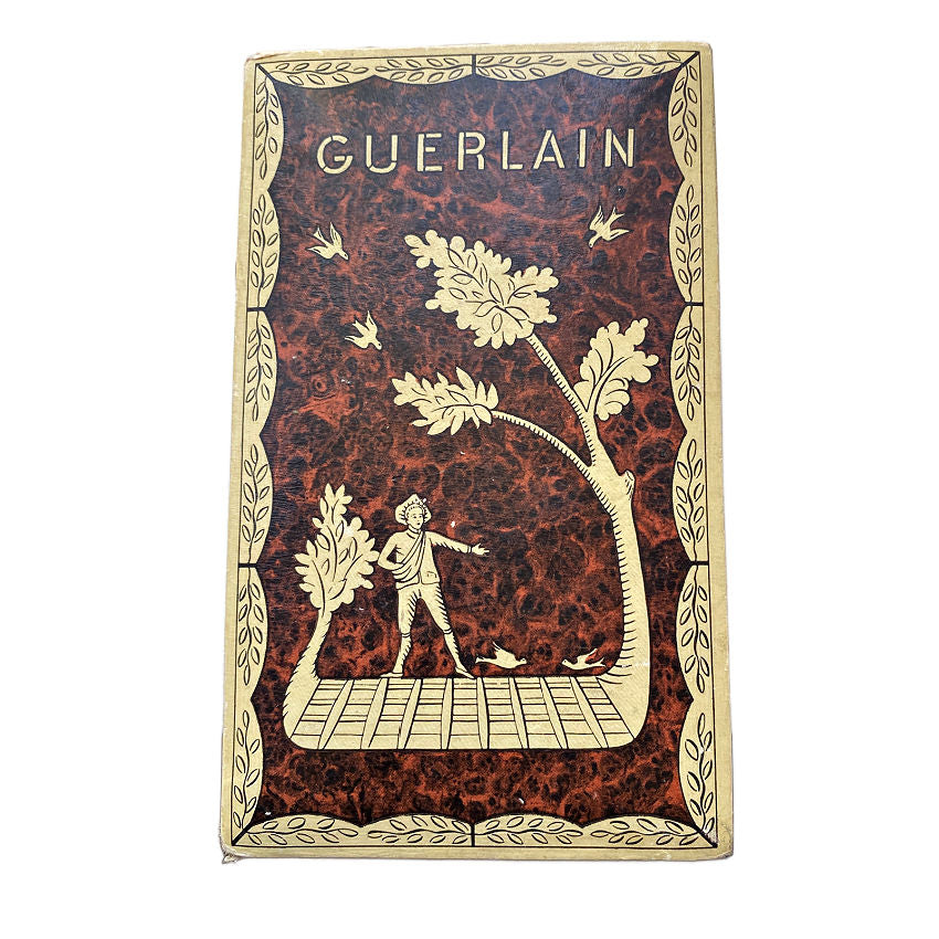 A vintage French Guerlain Parquet perfume box with a burled wood pattern, featuring a figure and leaf motifs, and the brand name 'GUERLAIN' at the top.