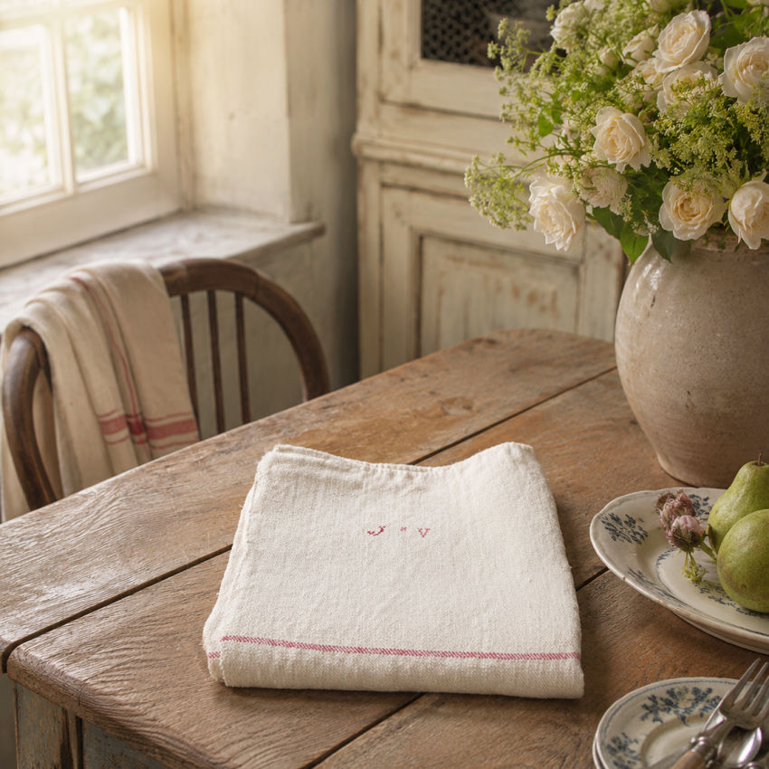 Antique French linen tablecloth styled on farmhouse table with European antiques