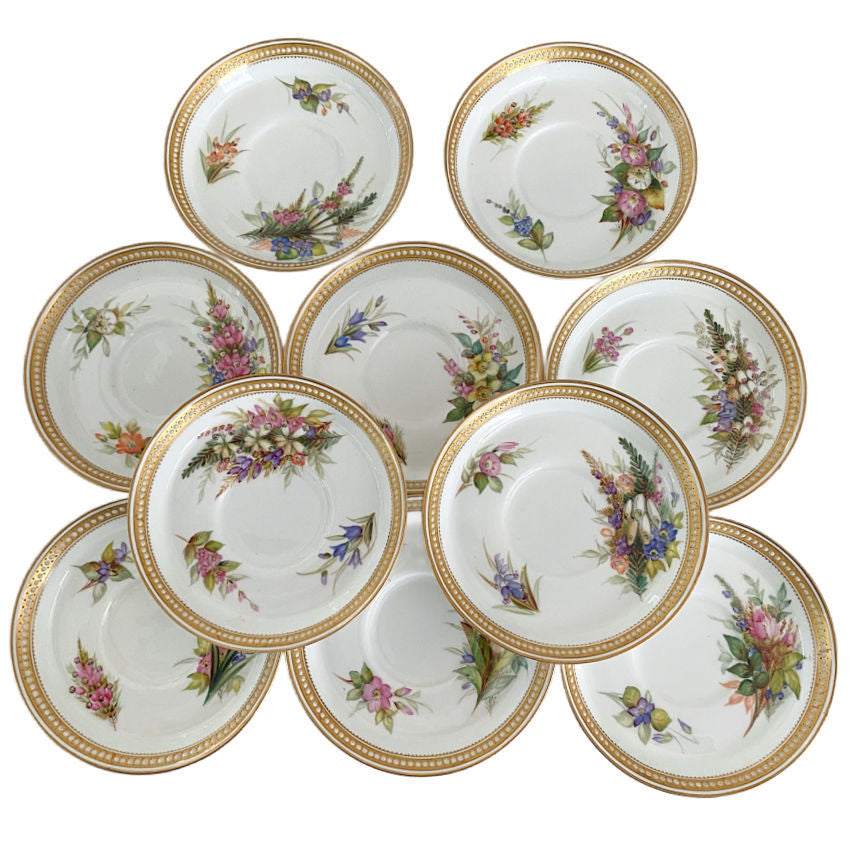 Ten antique Royal Worcester saucers with delicate floral painting, jeweled decoration, and gilt detailing