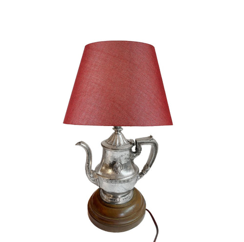 ✔️ Full view of 1940s hotel silver teapot lamp illuminated with warm ambient glow