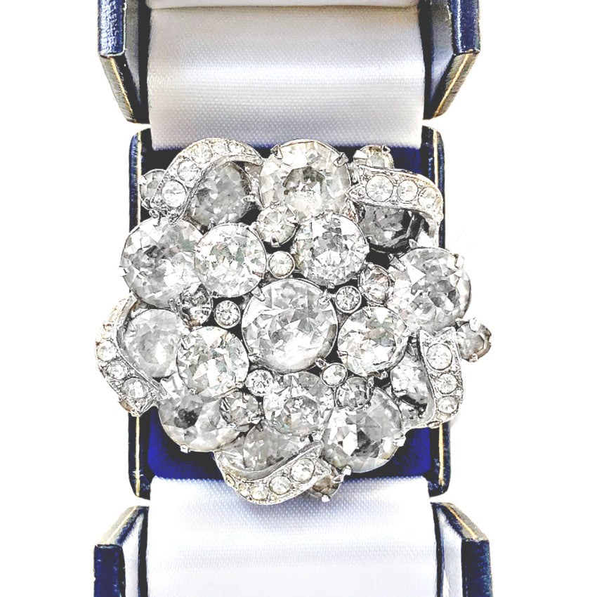 Signed 1940s Eisenberg pavé icing ribbon brooch with brilliant rhinestones in rhodium plating. Iconic vintage statement jewelry, highly collectible design.