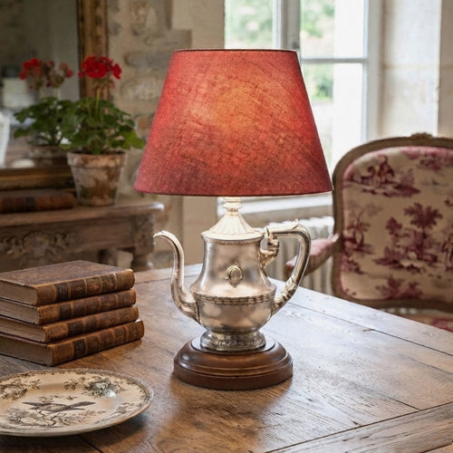 1940s hotel silver teapot lamp styled in French country living room on table with red toile chair and books