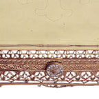 Close-up of the engraved cross and ornate floral brasswork on an antique French Bible stand