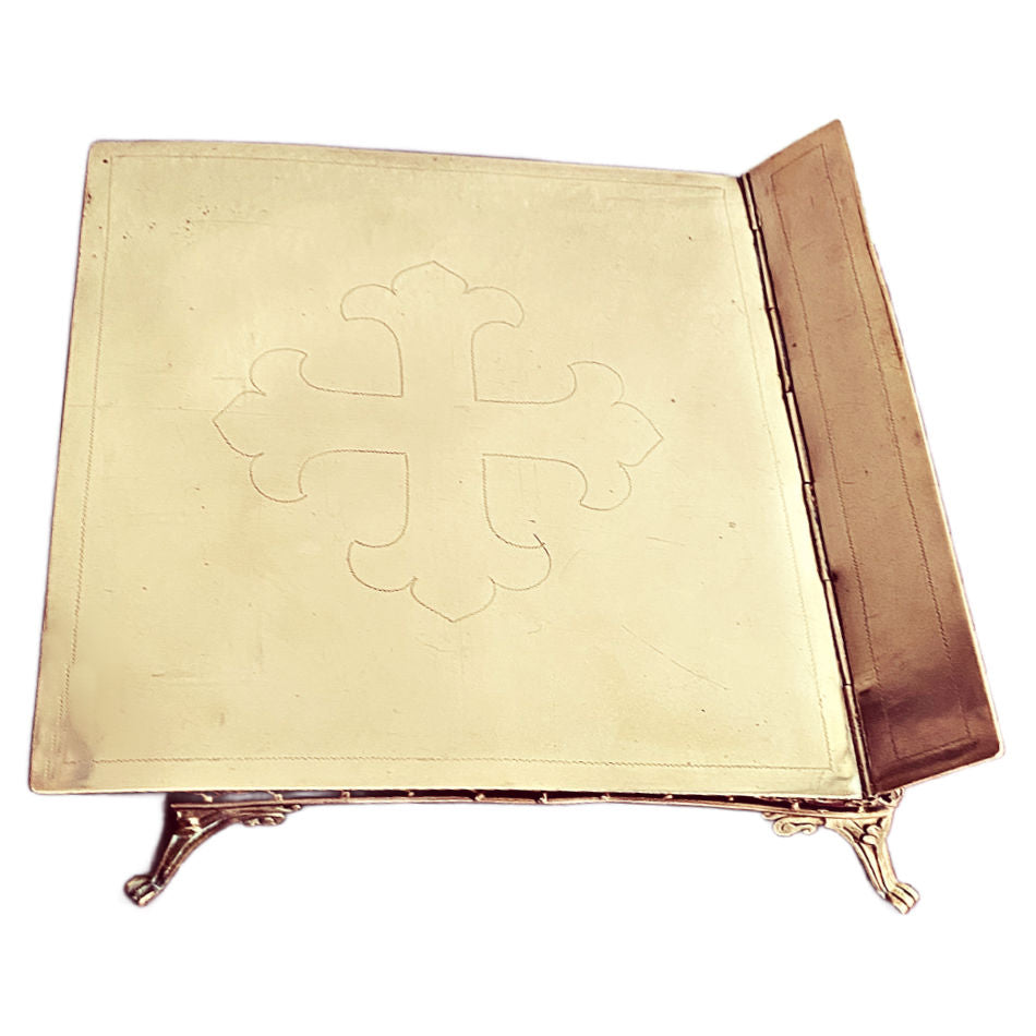 Close-up of the engraved cross top of an antique French Bible stand
