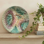 19th century English Majolica begonia plate styled on a wood shelf next to a stack of books an an ivy plant