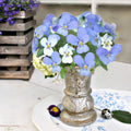 Close up of antique French "Pensée" floral relief showing the delicate petals of garden pansies on cast iron on an antique blue and white antique French floral platter