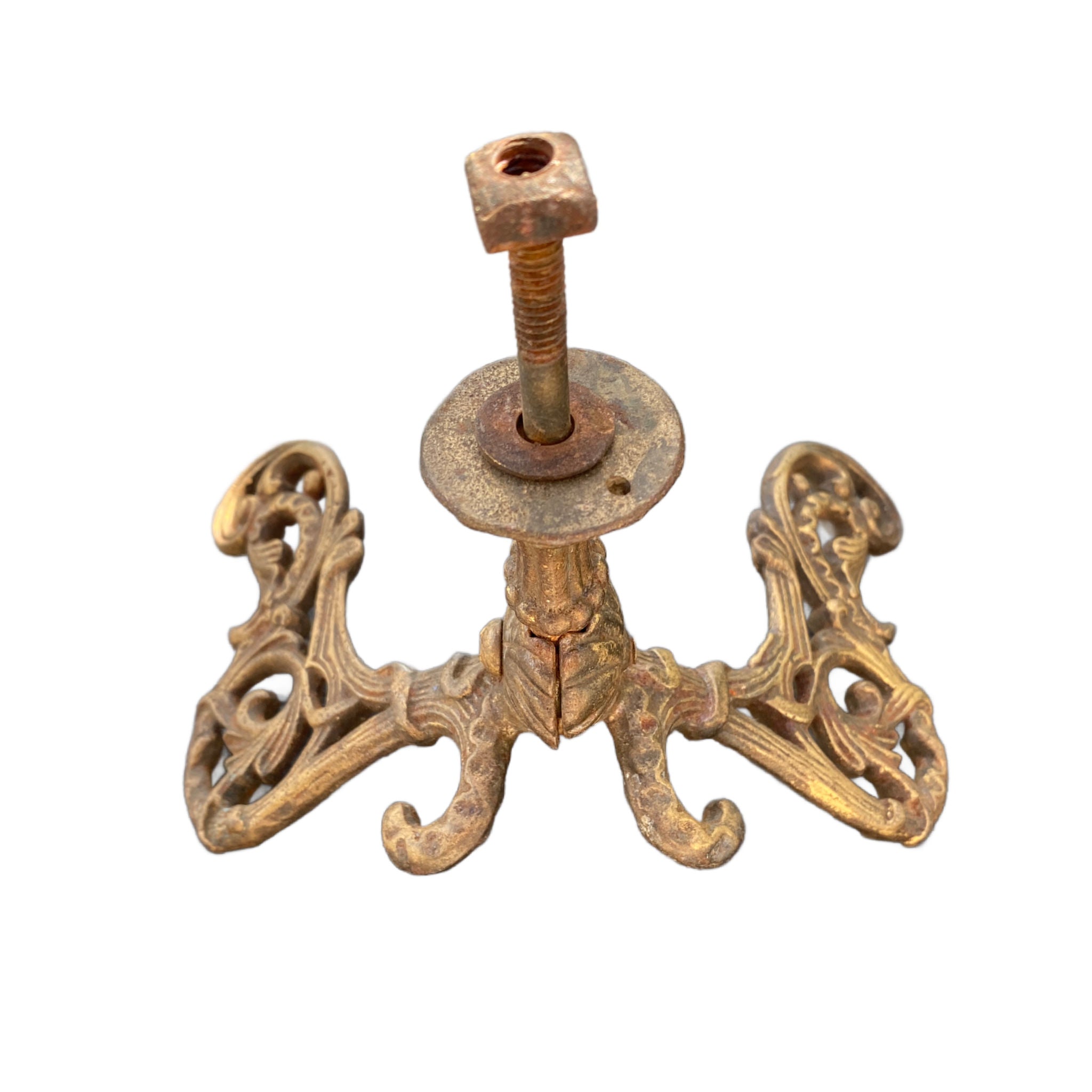 French chateau-style gilded iron wall hook with two scrolling arms and intricate 19th-century casting for luxury home decor. top view screw detail