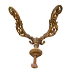 Antique Louis XV style double coat hook in heavy cast iron featuring decorative acanthus leaves and a weathered golden finish.