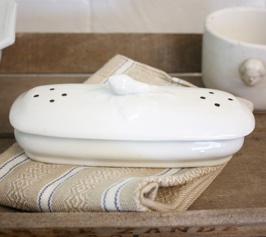A charming 19th century French ironstone razor or toothbrush holder with pierced lid and whimsical courgette finial. A delightful and increasingly difficult-to-find antique vanity piece on a wood top and an antique towel.