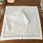 19th century French hand embroidered linen napkins styled on an elegant table