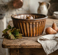 19th century French Alsace pottery cake mold on a French country table with pears, autumn leaves and linen towel