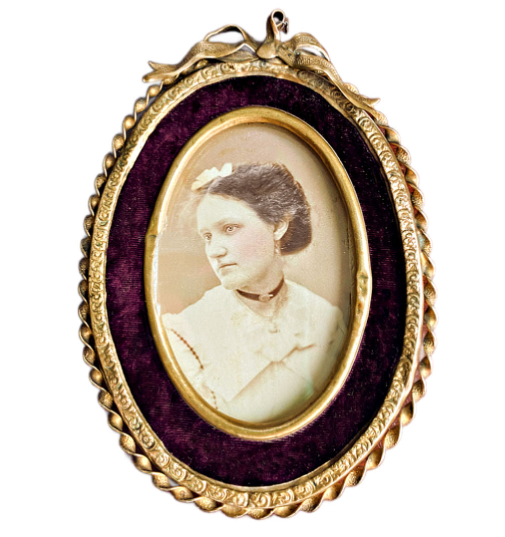 Antique 19th century gilt photograph frame with a twisted metal surround and a merlot velvet insert, displaying an image of a puppy inside.