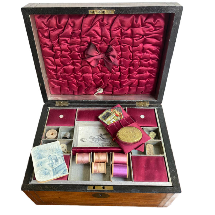 Antique 19th Century Inlaid Sewing Box with Silk Lining, opened to display various sewing tools and materials, including a French gilded pin cushion and metal boxes with fittings.