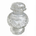 Antique cut glass jar with a scalloped rim, round cut top, and a faceted foot. It features intricate cut patterns and a domed lid with a flower design on top.