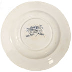 A detailed view of an 1870s French Sarreguemines Cérès pattern deep plate, showcasing intricate blue and white floral transferware details. showing back stamp