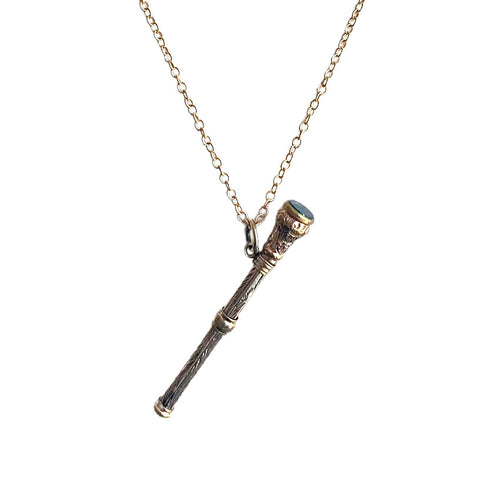 Close-up of antique gold-filled chatelaine pencil with engraved detail and bloodstone