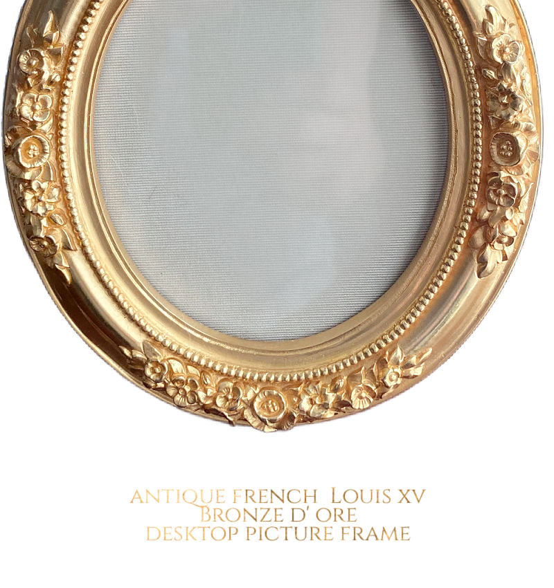 close up of ribbon bow crest on antique bronze doré frame rose floral details
