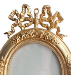 close up of ribbon bow crest on antique bronze doré frame