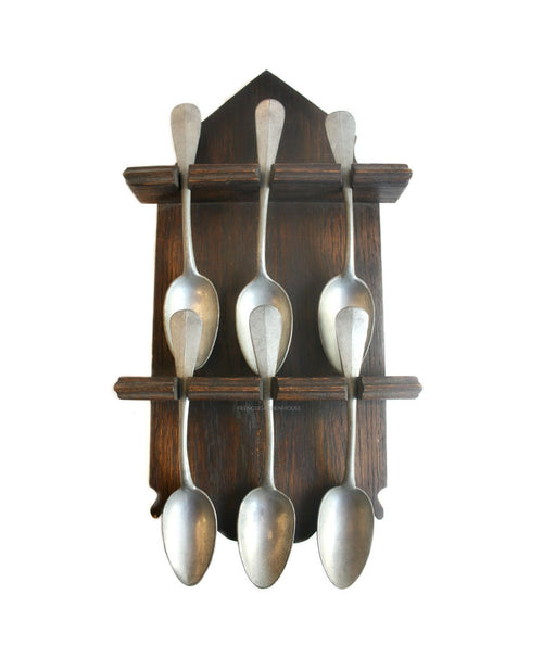 Antique French pewter spoons on wooden wall rack for country kitchen