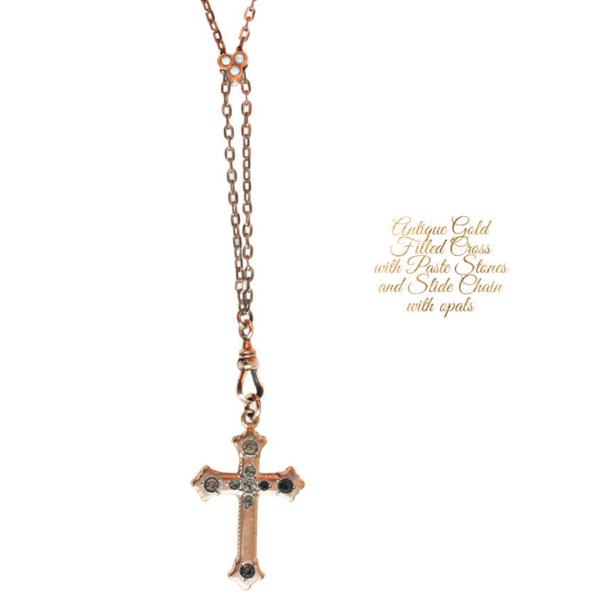 Large burnished antique gold cross with 14 karat gold filled link chain necklace. Teardrop blood garnet briolette dangles store in the center.