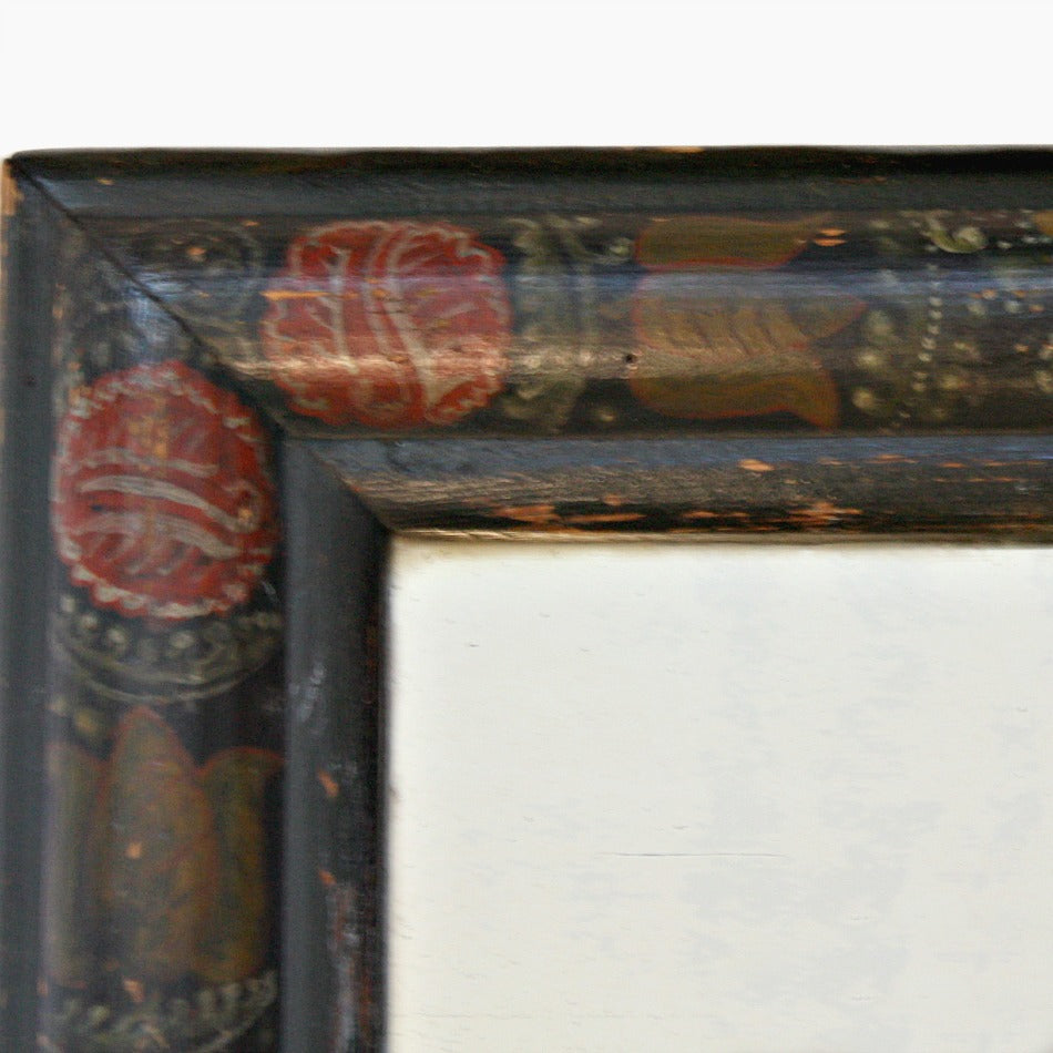 An early antique hand painted wood courting mirror with a country floral design, featuring large red tulips and foliate patterns in French Country colors.