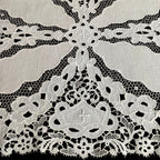 Close detail of antique linen cutwork flowers and embroidery