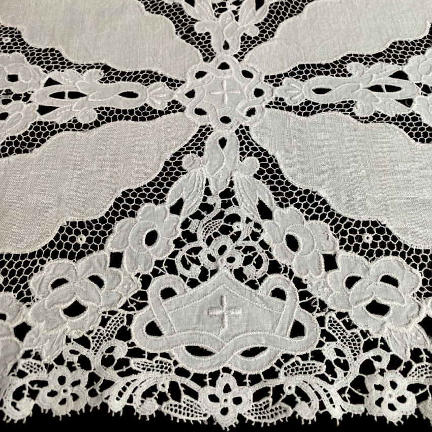 Close detail of antique linen cutwork flowers and embroidery