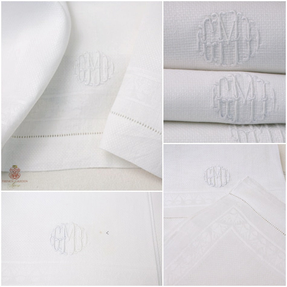 Close up of antique white linen guest towel showing padded bourdon monogram and hand sewn fagoting hem