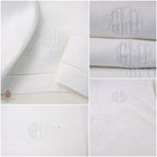 Close up of antique white linen guest towel showing padded bourdon monogram and hand sewn fagoting hem